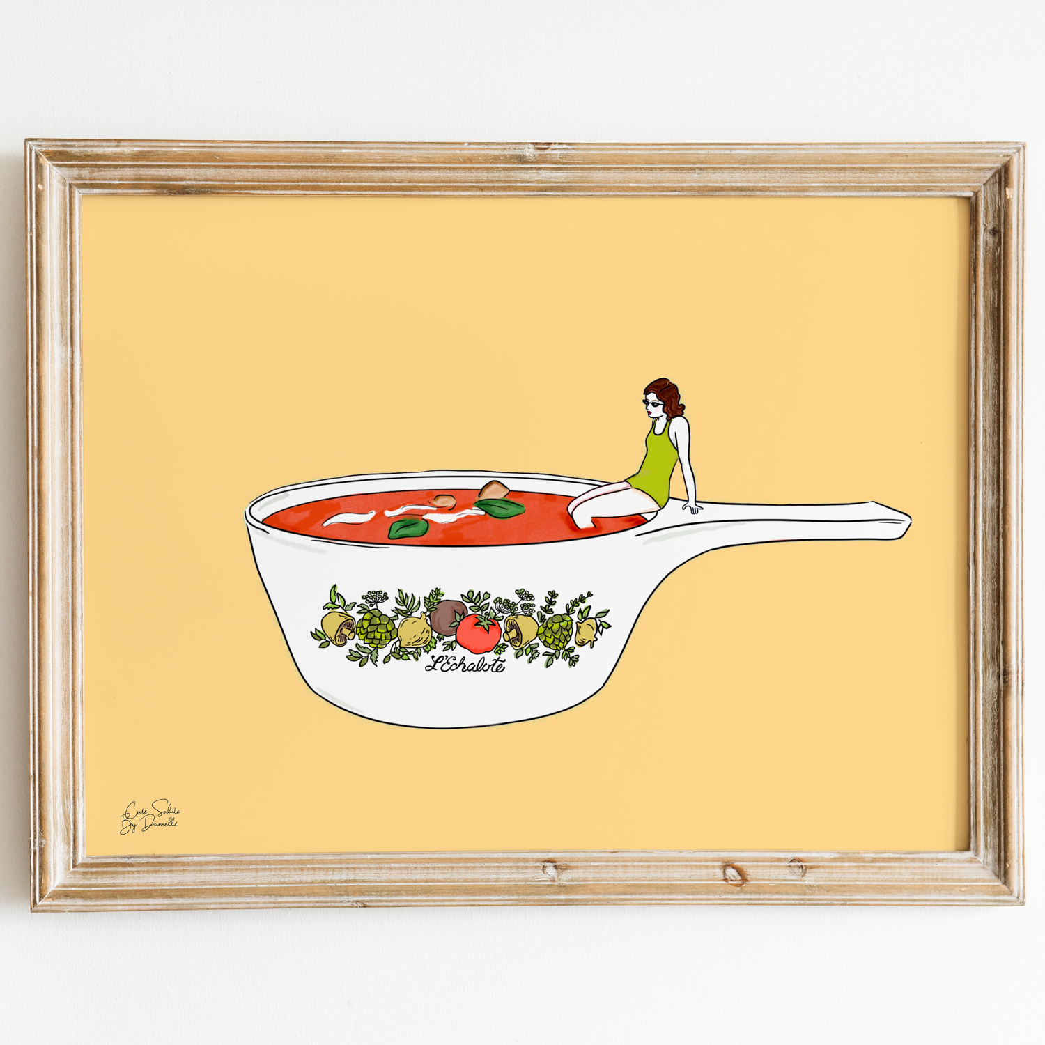 Framed artwork of a bowl of soup with a person reading, on a yellow background