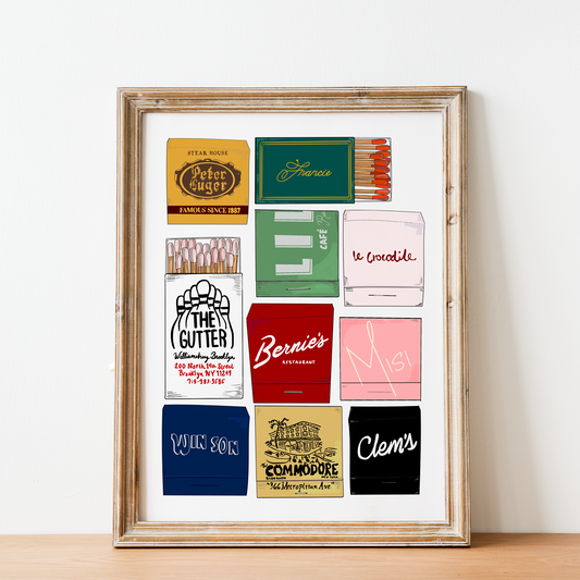 Framed collection of vintage matchbook covers on a white wall