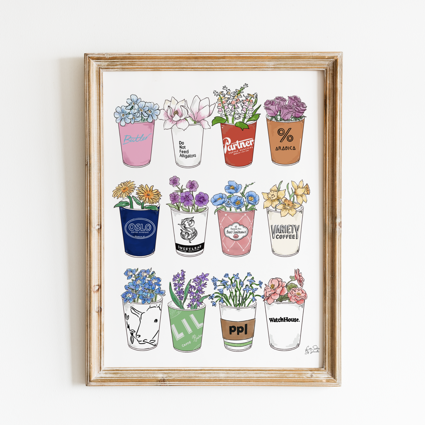 Framed artwork of various New York City coffee Cups with colorful labels on a white background