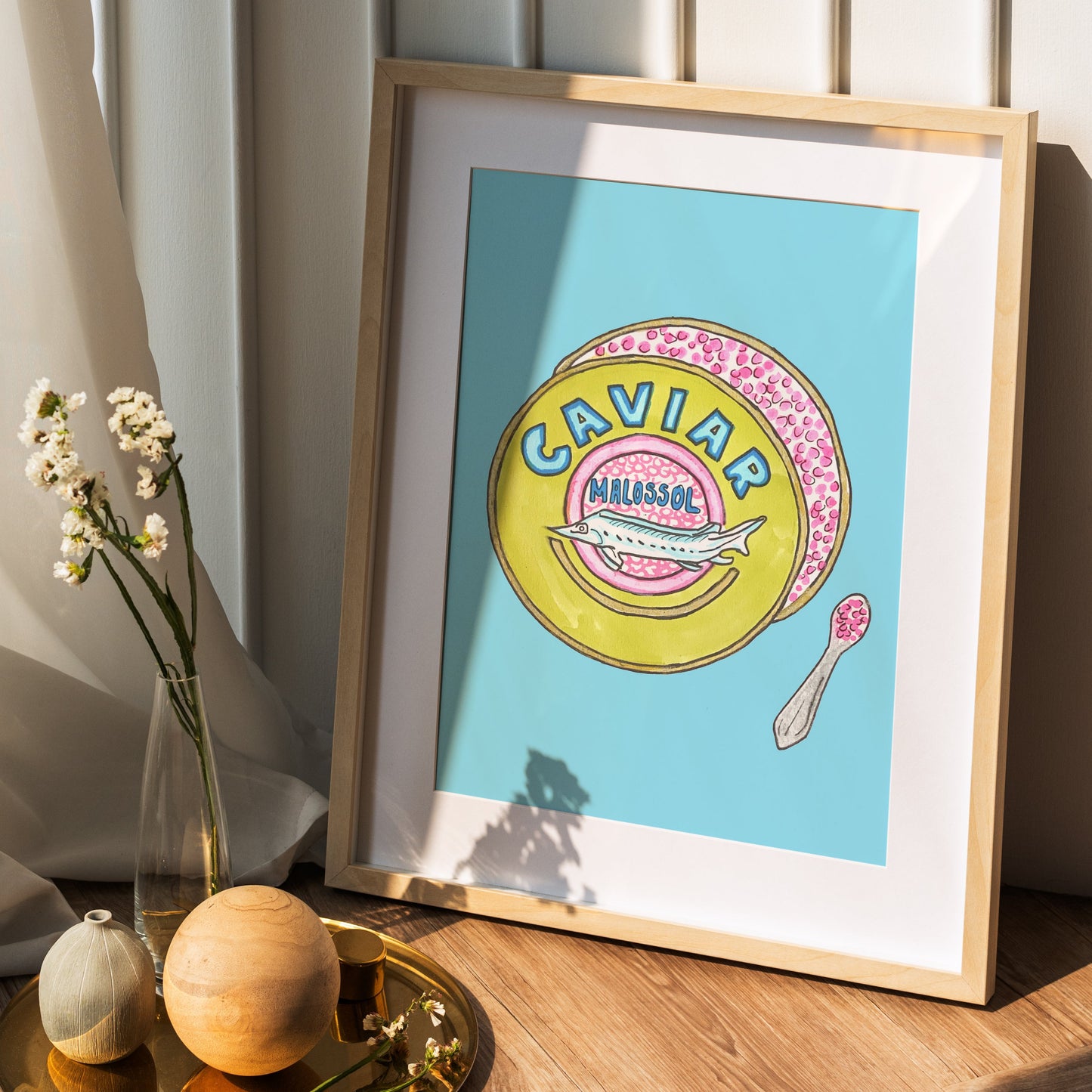 framed wall art of colorful caviar tin and spoon